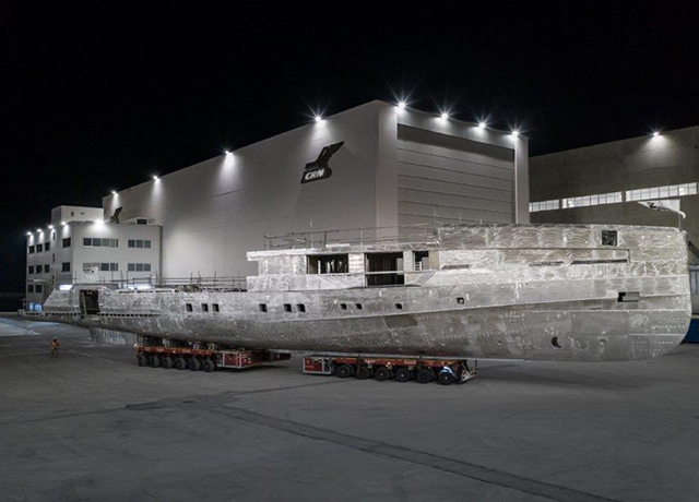 A bare aluminum hull shows the shape of the CRN 142 yacht under construction