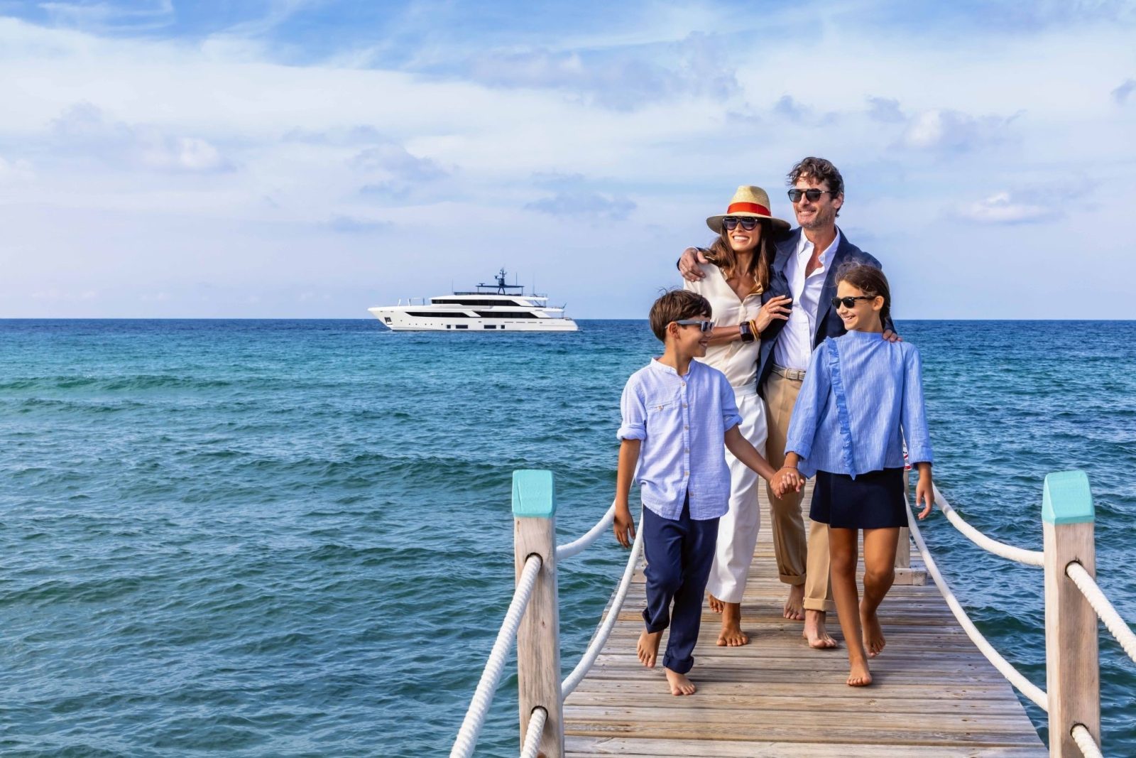 Custom Line Navetta 42 in the distance as a family walks from the dock to a new city to explore.