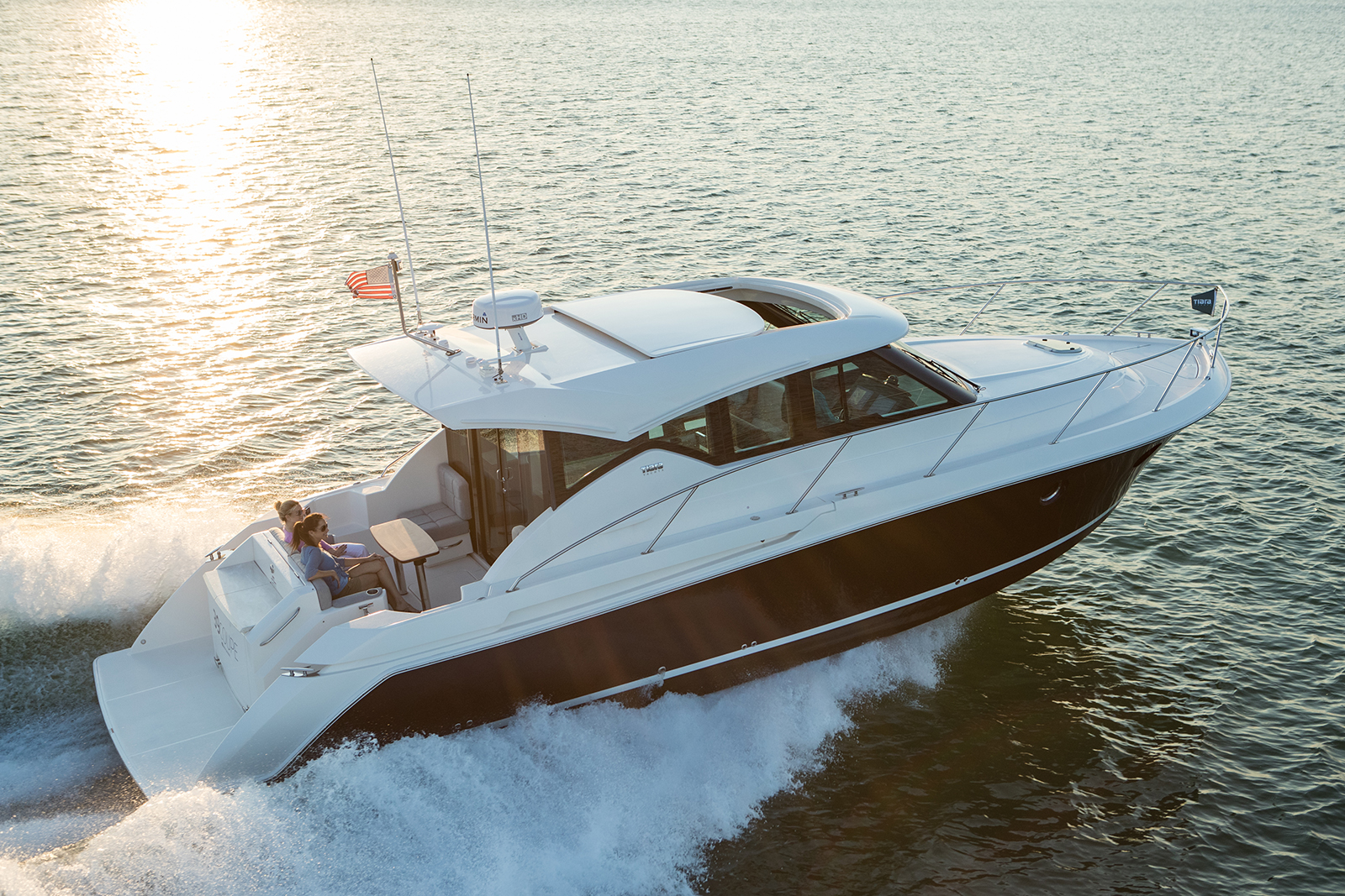 A family cruising the open ocean on a Tiara Yachts 39 Coupe.