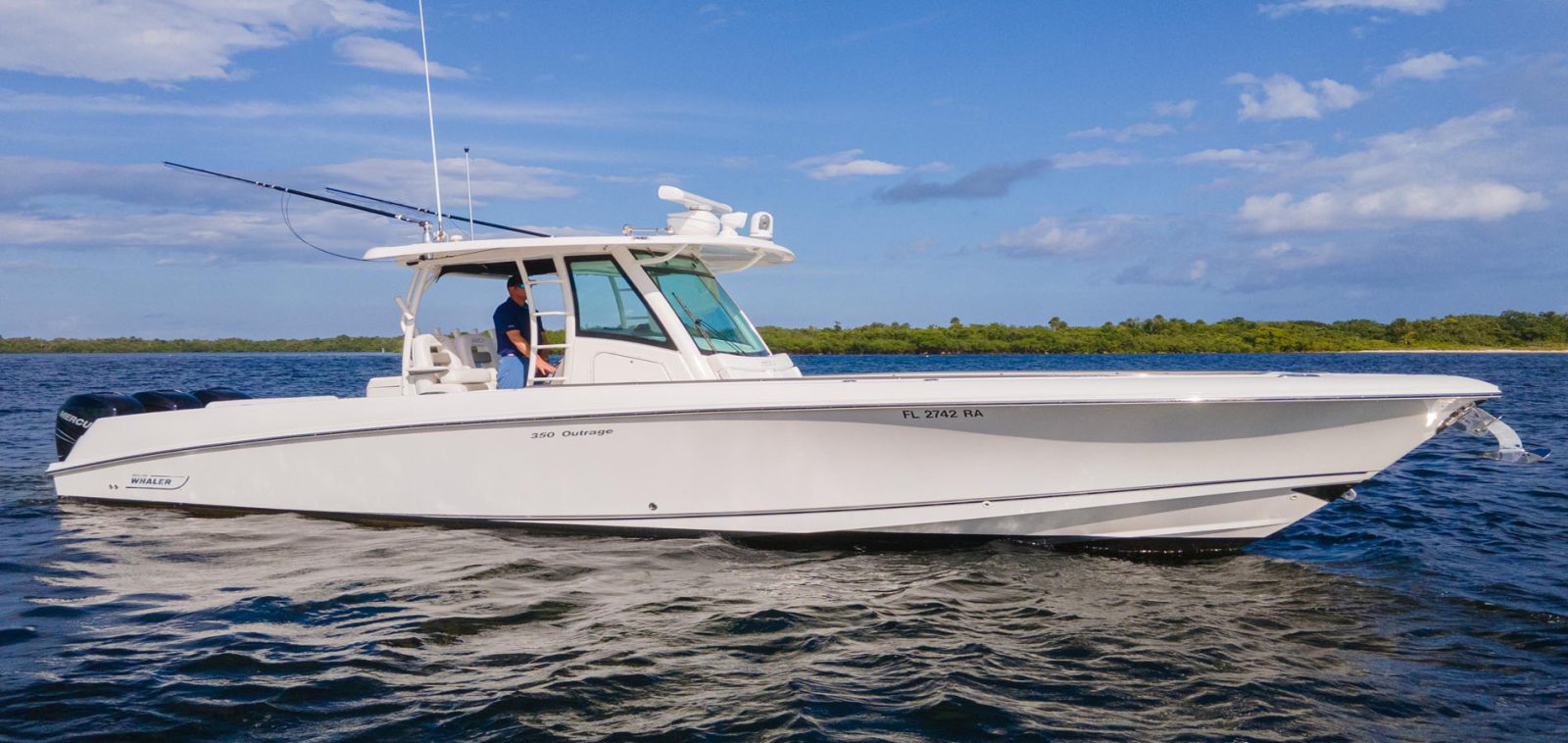 Boston Whaler cruising in the midday sun on the ocean.